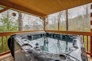 A hot tub on a wooden deck with a view of trees and mountains. - Mtn-view Bryson City Cabin: 1 Mi to Deep Creek! (Bryson City)
