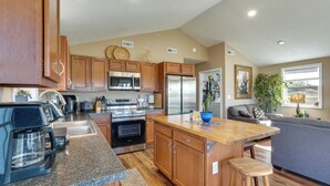 A modern kitchen with wooden cabinets, stainless steel appliances, and a granite countertop. - Fish, Play & Explore! Family Gem in Rural Richland (Richland)