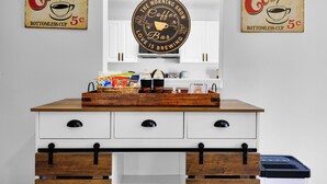 A kitchen counter with a coffee-themed sign, a coffee machine, and a tray of snacks. - Family Friendly Pensacola Home Near Gulf Breeze (Pensacola)