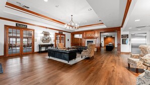 A spacious lobby with a grand staircase, a fireplace, and a sign indicating the Royale suite. - Pr66-8 4 Bedroom Condo (Branson)