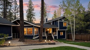 A two-story house with a front porch, a staircase, and a driveway. - Lakefront Escape with Private Dock, Hot Tub, AC, EV charger, & Game Room (Big Bear Lake)