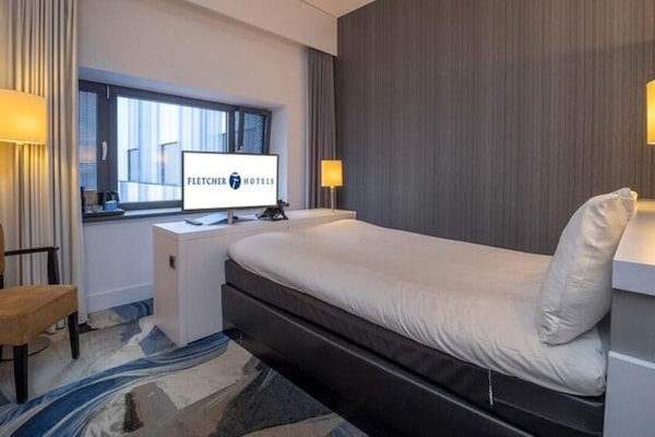 Relax into a peaceful night with warm lamps and plush bedding.