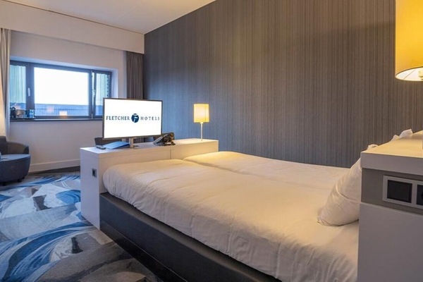 Unwind in a cozy, modern room with soft lighting.