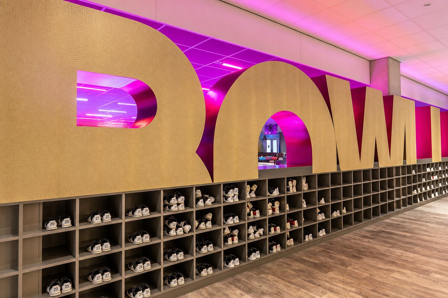 A shoe storage area with multiple shelves and a pink-lit ceiling.