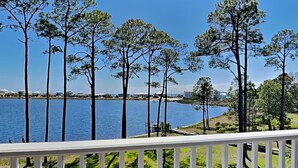 A view of a lake with tall trees and a white railing. - The Pearl At Oyster Lake | Chic Coastal Home, 0.4mi to Beach Access + Bikes (Santa Rosa  Beach)