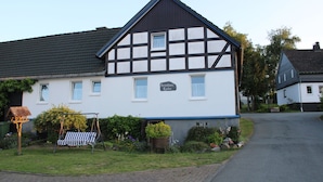 A traditional half-timbered building with a sign reading 'Ferenhaus Karles.' - BergZeit Karles | Winterberg—Your Favorite Spot on the Rothaarsteig•Ski•Hiking•Bike Park (Winterberg)