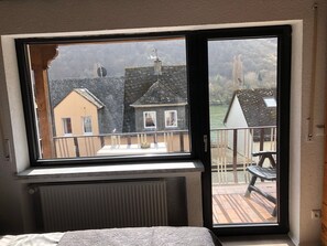 A room with a large window, a radiator, and a bed. - Room 2D, 2nd Floor with Shared Garden, Balcony and Wi-Fi (Klotten)