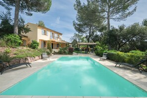A swimming pool with lounge chairs, a house, and surrounding trees. - 4 BEDROOM VILLA WITH PRIVATE POOL AND GARDEN (N°443) (La Motte)