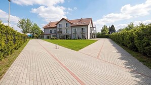 A large, modern two-story building with a flat roof and multiple windows. - Cozy Studio close to the Beach | Balcony | Parking (Grzybowo)