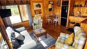 A cozy cabin interior with a living room, dining area, and kitchen. - No 6 (Enniskillen)