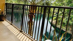 A balcony with a view of a water body, surrounded by greenery and a metal railing. - Island Club 106 | Pool, Hot Tub, Tennis & Beach (Hilton Head Island)