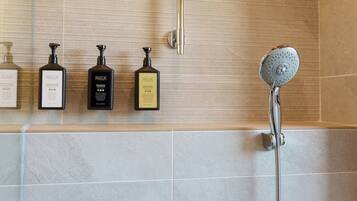 A bathroom with a shower, a toilet, and a sink.