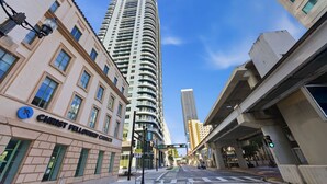 A city street with a tall building, a sign for Christ Fellowship Church, and an overpass. - Modern Studio Downtown Miami Amazing Amenities (Miami)