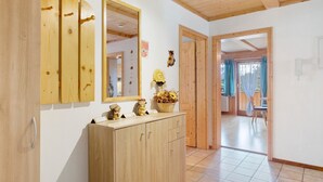 A wooden interior with a cabinet, mirrors, and a doorway leading to another room. - Apartment Sommerruhe in Jostal near Titisee (Titisee-Neustadt)