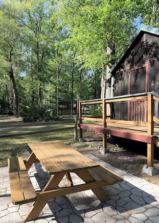 Outdoor dining. Deluxe Cabin - The Bear Den - Our Deluxe Cabins offer comfort with a true Okefenokee feel. Climate controlled, private, and set in a quiet part of the campground.