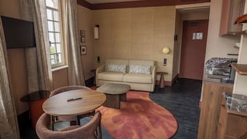 A compact living space with a sofa, a round table, and a small coffee table.
