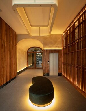Ein modernes Interieur mit einer gebogenen Sitzecke, Holzvertäfelung und einem großen Fenster.