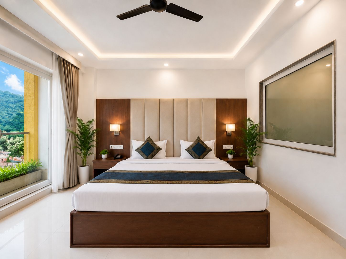 A modern hotel room with a large bed, bedside lamps, a ceiling fan, and a view of greenery outside.