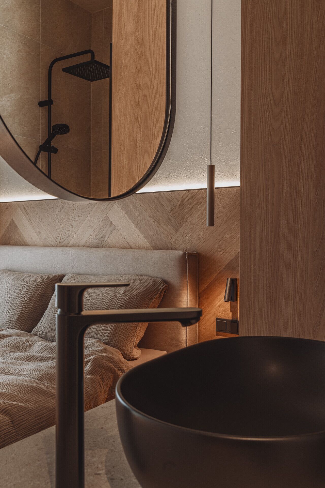 Un baño moderno con tocador de madera, un espejo grande y zona de ducha.