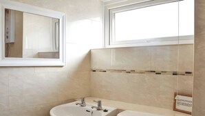 A bathroom with a sink, toilet, and a mirror. - Crag Barn Cottage (Penrith)