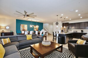 A modern living room with a sofa, coffee table, and patterned rug. - Last Minute Disney Getaway! Luxury Villa with Private Pool, Game Room & Themed Bedrooms. Book Now! #152563 (Orlando)