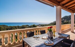 A table set for dining with a view of the sea and hills. - Villa 'Leonie' with Sea View, Wi-Fi and Air Conditioning (Capdepera)