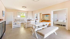 A spacious living area with a dining table, sofas, and a kitchen area. - Villa Limanaki, Villa Limanaki Lavrion Port (Lavrio)