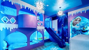 A room with a bed, a slide, and a wall with a character decoration. - Last Minute Disney Getaway! Private Pool, Game Room & Themed Bedrooms. Book Now! #163621 (Orlando)