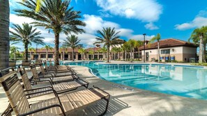 A swimming pool with lounge chairs, palm trees, and a clear sky. - Last Minute Disney Getaway! Private Pool, Game Room & Themed Bedrooms. Book Now! #163645 (Orlando)