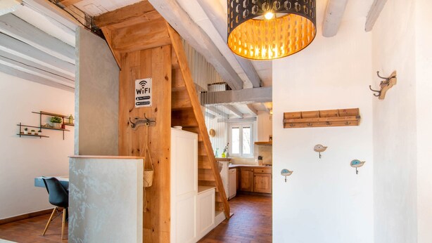 A wooden interior with a staircase, a hanging light fixture, and a WiFi sign. - Charming “La Ferme du Château” – Private Terrace, Peaceful Setting, Fresh Air (Venon)