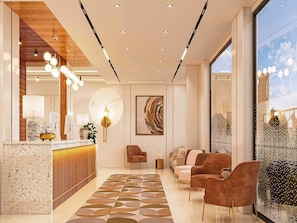 Um lobby moderno com balcão de recepção, área de estar e grandes janelas.