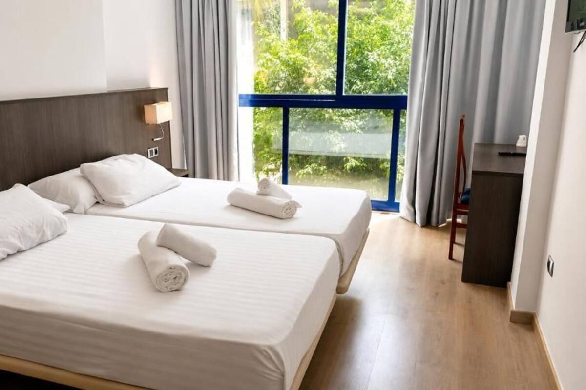 Premium bedding, desk, laptop workspace, blackout curtains