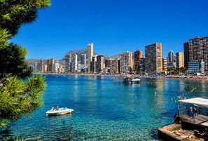 A coastal cityscape with clear blue waters, a marina, and high-rise buildings. - Hotel Bossh Lido (Benidorm)