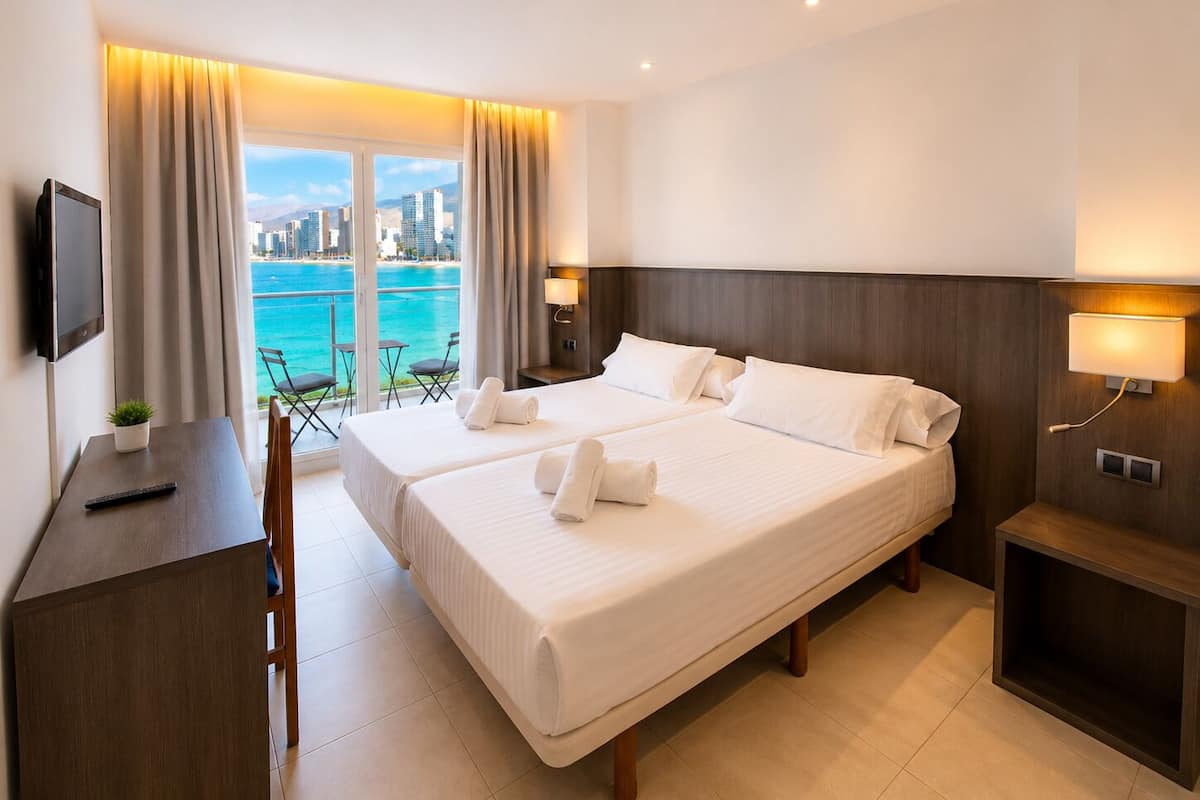 Premium bedding, desk, laptop workspace, blackout curtains