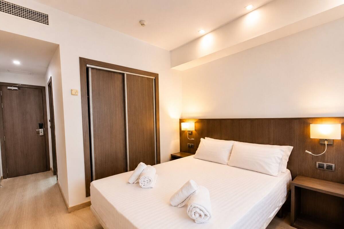 Premium bedding, desk, laptop workspace, blackout curtains