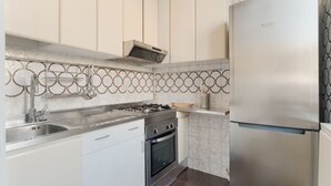 A modern kitchen with stainless steel appliances, a gas stove, oven, and a built-in sink. - GuestHost - Cozy apartment of approximately 55 m2, able to accommodate up to 4 people, located on the first floor of a building with lift (NOT suitable for people in wheelchairs).The property is located in the Risorgimento district, in a residential area (Milan)
