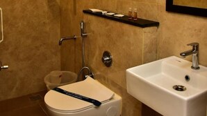 A bathroom with a toilet, a sink, and a shower. - Narayani residency (Tiruvannamalai)