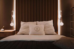 A neatly made bed with white linens and a pillow with a monogram, set against a wall with vertical wooden slats. - Holiday Home, Bedroom With Bathtub, Jacuzzi (Koscierzyna)