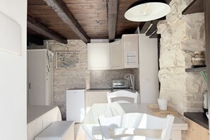 A compact kitchen with white cabinets, a small refrigerator, a toaster, and a map on the wall. - N310 - Numana, new studio apartment with air conditioning (Numana)