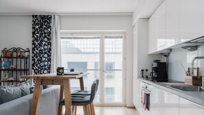 Eine moderne Küche mit Essbereich, einer Treppe und Blick auf die Stadt.