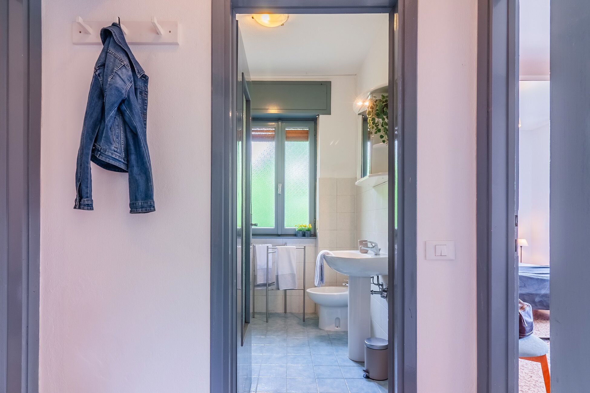 A bathroom with a toilet, bidet, and sink.