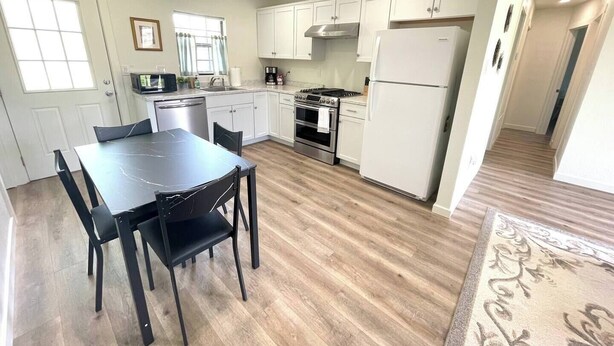 A compact kitchen with white cabinets, a black dining table, and a patterned rug. - 🏡 Abilene Restful Retreat – 2BR / 2BA ✨<br>Enjoy a cozy and relaxing stay in Abilene. This comfortable home is perfect for families, friends, or business travelers and is conveniently located near restaurants, shopping, and local attractions. 🌟 (Abilene)