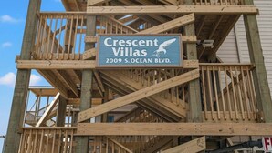 A wooden construction framework with a sign for Crescent Villas at 2009 S. Ocean Blvd. - Crescent Villas 302- 2 Bedroom Condo- Pool (North Myrtle Beach)