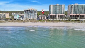 A coastal hotel area with beachfront properties, a beach, and ocean views. - Crescent Villas 302- 2 Bedroom Condo- Pool (North Myrtle Beach)