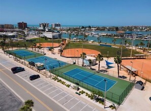 An aerial view of a sports complex with tennis courts, a baseball field, and a marina. - NEW! Madeira Beach Family Vacation Home - Walkable to Beach (Madeira Beach)
