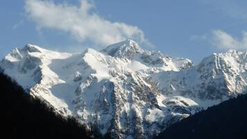 A snow-covered mountain range with rugged peaks and a clear sky.