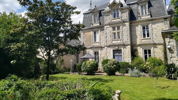 A large stone building with multiple windows and a prominent tower. - LE GITE DU CHATEAU NEAR MARAIS POITEVIN (Fors)