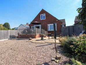 A residential property with a brick house, a gravel driveway, and a wooden fence. - The Rumbles (Ludlow)