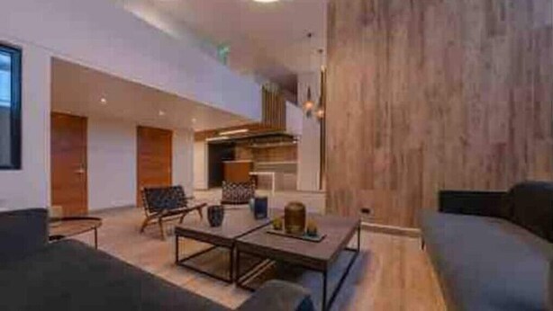 A spacious living area with a sofa, coffee table, and a fireplace. - River view Downtown apartment 12th floor (Valdivia)