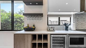 A modern kitchen with a built-in wine rack, a toaster, and a refrigerator.